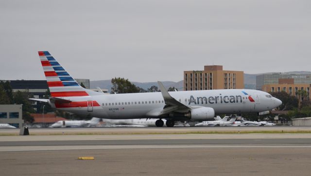 Boeing 737-800 (N829NN) - This American 737-800 is just beginning its rotation from runway 20R. Photo was taken in the parking lot of the Lyon Air Museum and Signatures west ramp.