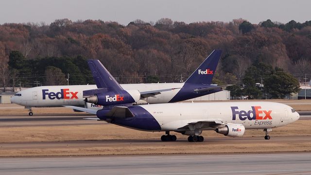 McDonnell Douglas DC-10 (N372FE) - Mackenzie taxis for departure while B77L N855FD "Ariannna" taxis to the Hub after arrival.