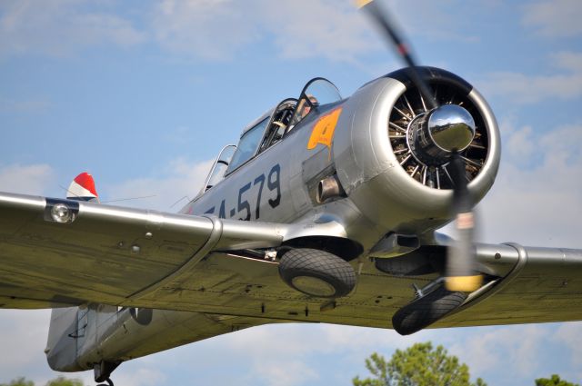 North American T-6 Texan (N93579) - This picture was taken at the Reklaw Fly-In. I was standing at the end of the grass runway as it took off overhead.