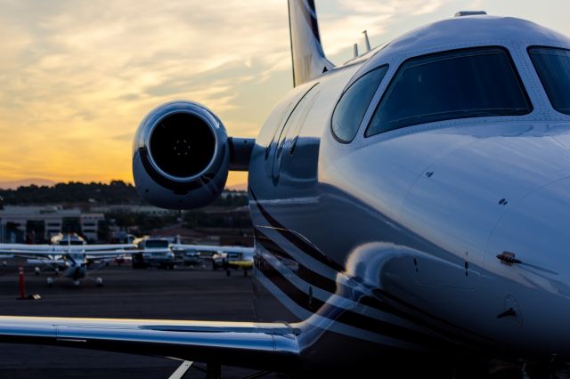 — — - Premier 1 at Sunrise on the ramp in front of Western Flight at KCRQ.