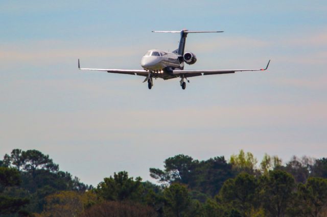 Embraer Phenom 300 (N1WC) - N1WC is a 2006 Embraer Phenom 300 seen here on final approach at Atlanta's PDK executive airport. The aircraft was coming from Sebring Florida after the conclusion of the IMSA 12 hours at Sebring race. I shot this with a Canon 500mm lens with a 1.4x extender making the focal length 700mm. Camera settings were 1/2000 shutter, F5.6, ISO 125. Please check out my other aviation photography. Votes and positive comments are greatly appreciated. Inquiries about prints or licensing of this photo can be sent to Info@Flews.com