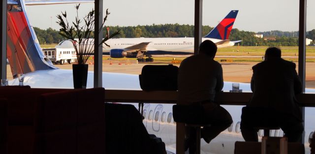 BOEING 767-400 (N825MH) - Also N942DN (MD90) in the foreground.  Taken at Delta Sky Club Concourse E.