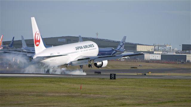 BOEING 767-300 (JA657J) - BOE973 a B767-300 makes some nice tire smoke landing on runway 16R at the end of its maiden flight. Photographed 10/9/11.