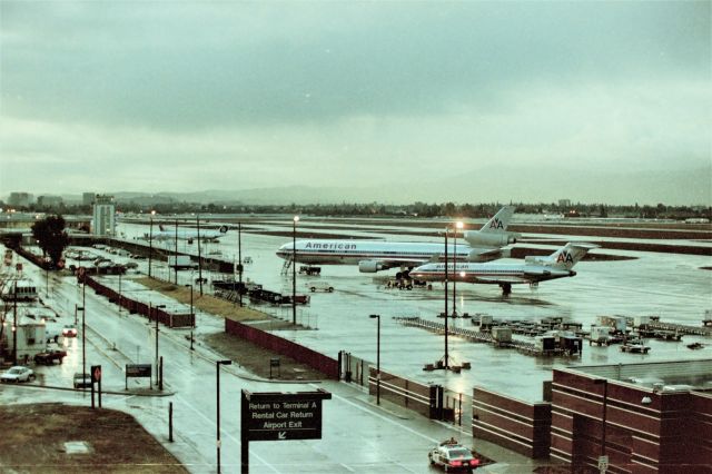 Boeing 727-100 (N1974) - KSJC - Unknown year, the SJPD patrol car at the bottom looks like a 1992-94 Chevy Caprice plus the American MD-11 in the photo on the remote ramp ( back then ) dates this photo early 90s. Online records for the American Boeing 727 shows CN 18430 LN: 31 delv April 4 1964 2 months before we moved to California the 1st time. Then a private 727 Operator about yr 2000. I may have seen this new at BFI and then again here, apprx 28 years later at San Jose. The 727 was used for a flight as I have pictures of the 727 being towed to one of the A gates. I'll post one of those next. Rainy day conditions at San Jose meant 12R operations - the view was great here until airport officials ruined it.....