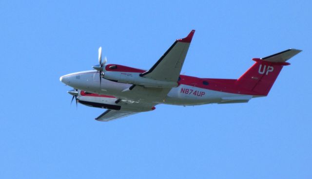 Beechcraft Super King Air 350 (N874UP) - Shortly after departing is this 2017 Beechcraft Super King Air 350 Wheels Up "Heart Health" red colored livery in the Spring of 2019.