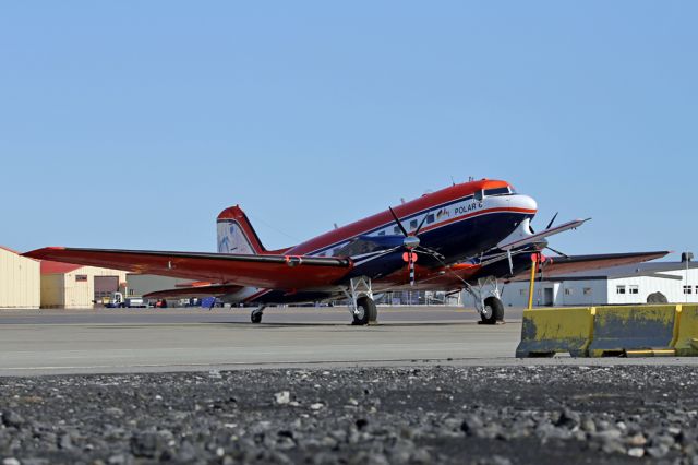 Douglas DC-3 (turbine) (C-GHGF) - On a stopover at Keflavik (6 July 2019) having arrived from Wick the day before on the way back to Canada.  The fences on this part of Keflavik aren't friendly to photography so getting low to find a gap was necessary... much to the displeasure of old knees.