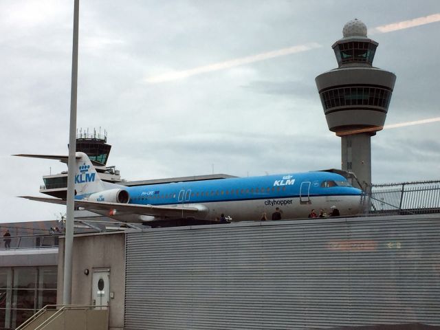 Fokker 100 (PH-OFE) - The Schiphol (Amsterdam Airport) Control Tower stands guard over the retired KLMs  PH-OFE Fokker F100