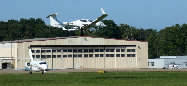 Diamond Twin Star (N496TS) - About to touch down is this 2007 Diamond DA-42 Twin Star while a Cessna Latitute holds for departure in the Summer of 2023.