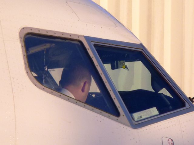 Boeing 737-700 (N618AS) - The First Officer is busy getting the plane ready to push.