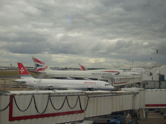 Boeing 747-400 — - A British Airways 747 parked next to an Air Malta A320