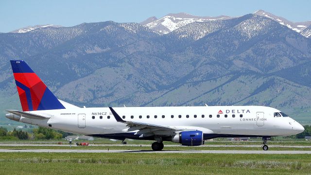 Embraer 175 (N614CZ) - Early summer at Gallatin Field, Bridgers in background