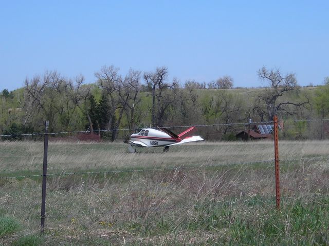 Beechcraft 35 Bonanza (N8SM) - damaged plane in field ... you can see that the left wing is missing