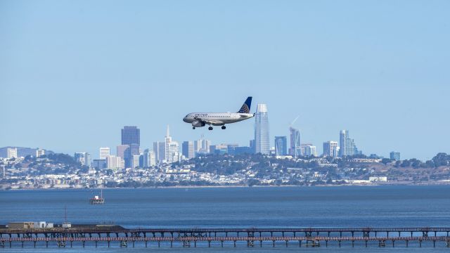 Airbus A319 (N836UA) - On final for 28L with the San Fransisco skyline in the distance.br /11/5/17