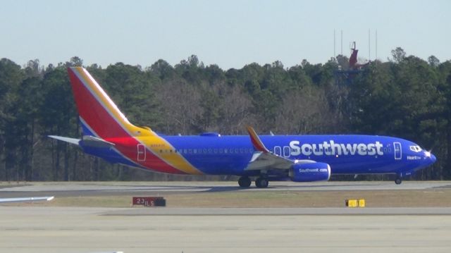 Boeing 737-800 (N8642E) - "Hart 1" turning onto runway 23L as Southwest 214 to Baltimore.  Taken December 11, 2014.