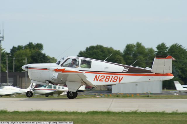 Beechcraft 35 Bonanza (N2819V) - Landing at Oshkosh Monday morning at the start of Air Venture 2009. This Bonanza was the 52nd one built. Owned and maintained by the Elgin Skysnoopers Flying club in northern IL. A private club of seven members.