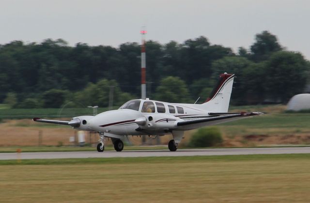 Beechcraft Baron (58) (N25RM) - Using rwy 27 in summer of 2012...