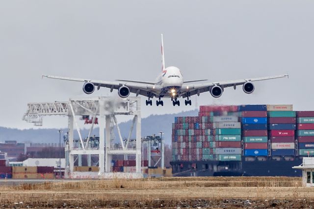 Airbus A380-800 (G-XLEE) - First scheduled BA A380 flight to Boston. Landing between a cargo vessel and an AT-AT.