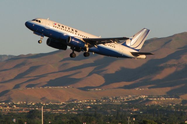 Airbus A319 (N811UA) - Therea a great Dean Hoisak pic of N811UA arriving Calgary (CYYC) that is already in the FA photo gallery, and in Deans pic N811UA is dressed in the old gray UA livery. In this pic, N811UA, departing Reno Tahoe Internationals runway 16R at 6:24 AM, is wearing UAs "Blue Tulip" scheme.  Sometime in the future, it will be getting new paint yet again, and hopefully someone will catch it wearing the Unicon scheme.  Then it will appear in FAs gallery in all three liveries.