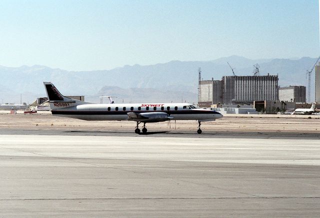 Mooney M-20 (N2699Y) - KLAS - Aug 1988 view looking west as this SLC bound Metroliner taxis past the Excalibur under construction over on the vegas Strip.