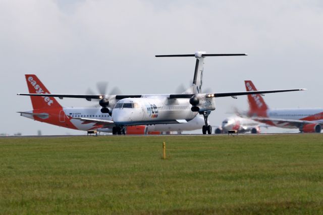 de Havilland Dash 8-400 (G-ECOA) - BEE453 departs to Jersey with a variety of Easyjet and Jet2 aircraft in the background