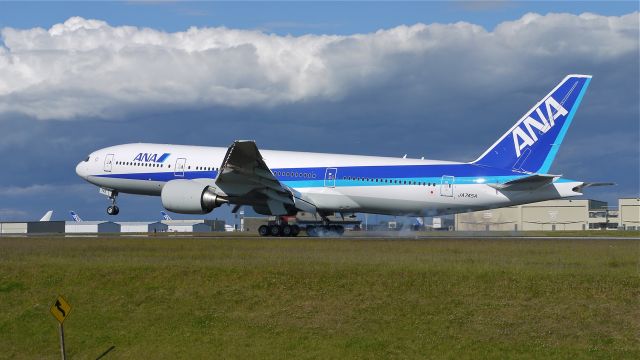 Boeing 777-200 (JA745A) - BOE595 touching down on runway 34L to complete its maiden flight on 6/13/13. (LN:1112  cn 40904).