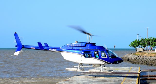 Bell JetRanger (VH-BVX) - A new load of tourists departing from the helipad in Cairns.