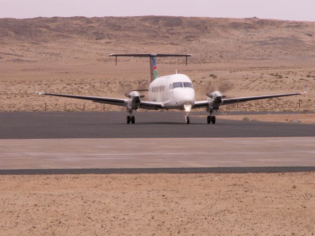 Beechcraft 1900 (V5-OWN) - Air Namibia Beech 1900D V5-OWN arriving at terminal LUD after a windy landing on the rwy. Photo made 08.09.2010, half an hour before departing directly to WDH with this beautiful bird.