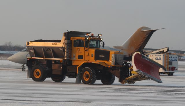 — — - Photobombed by Plow 31 at Gary Regional airport at the Deicing Pad.