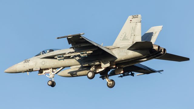 — — - Sunset arrival for this USN, F-18 Super Hornet. Later that evening you could hear these same aircraft, high over head during night operations. Note the small bombs and missle, mounted under the port and starboard wing.