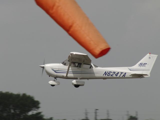 Cessna Skyhawk (N624TA) - N264TA passes the windsock at West Houston airport.