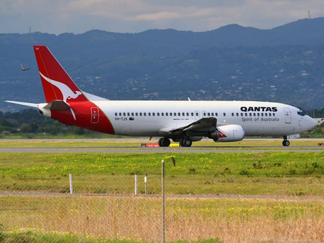 BOEING 737-400 (VH-TJS) - On taxi-way heading for take off on runway 05. Thursday 12th July 2012.