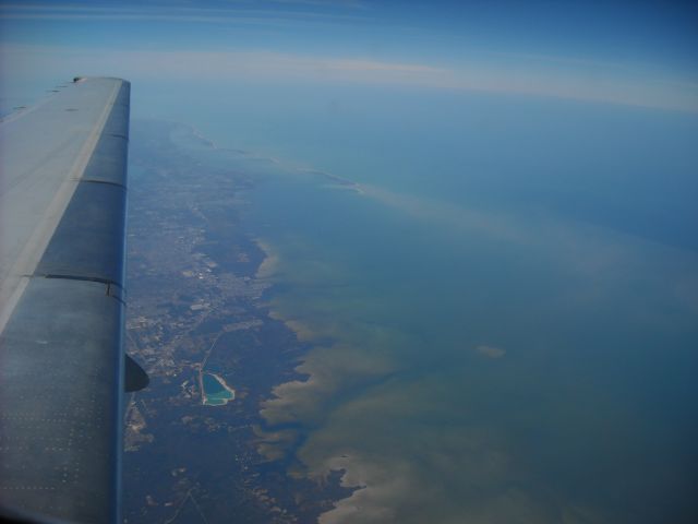 — — - Beginning to fly over the northeast corner of the Gulf of Mexico on TRS858 KMCO-KMCI Feb 2010. North Anclote Key, FL in the distance.