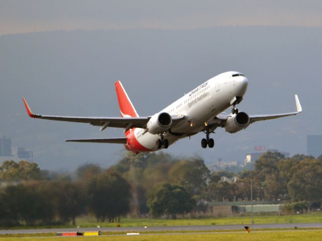 Boeing 737-800 (VH-VYF) - Getting airborne off runway 23 on a gloomy, cold winters day.  Wednesday 4th July 2012.