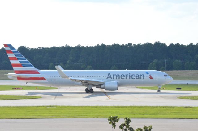 BOEING 767-300 (N392AN) - American 174 taxing to runway 23R for departure out to London Heathrow at 6;10 PM EDT.  Taken June 30, 2016 with Nikon D3200 mounting 55-200mm lens.   