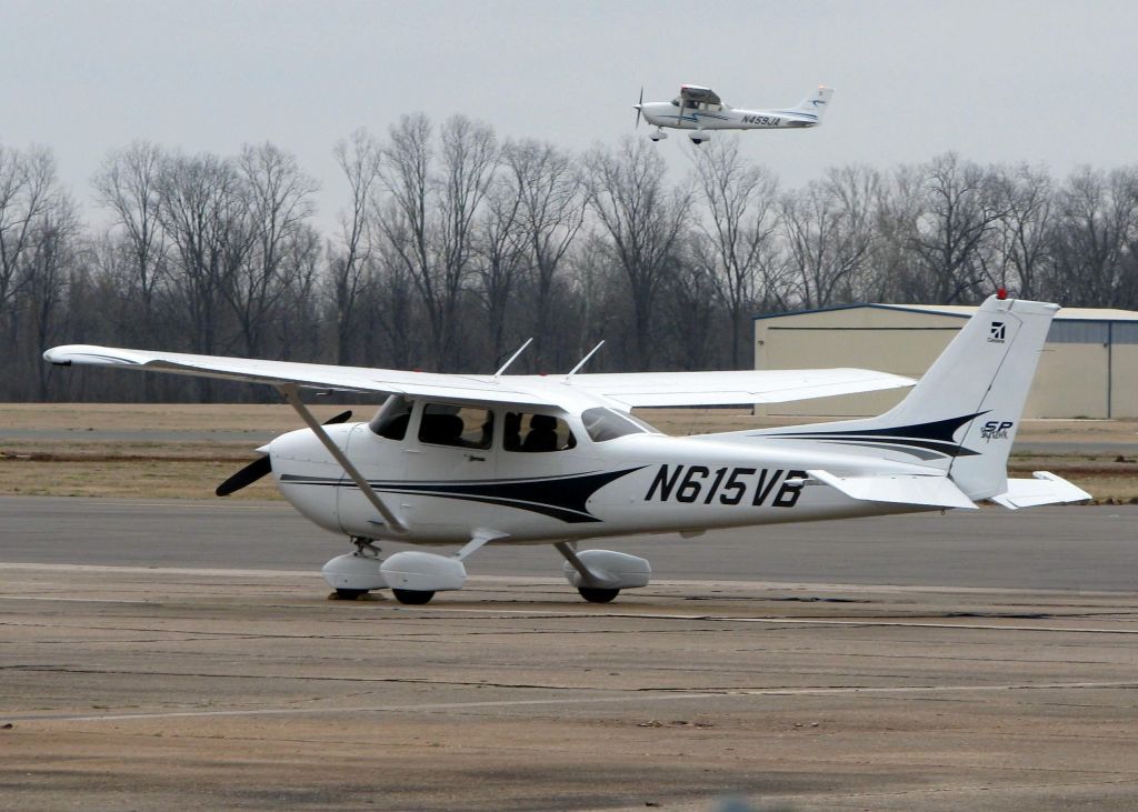 Cessna Skyhawk (N615VB) - Parked at Downtown Shreveport with another Cessna (N459JA) lifting off of runway 32 in the background.