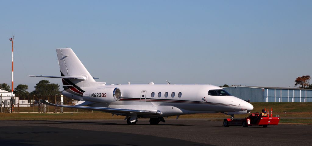 Cessna Citation Latitude (N623QS) - Receiving a tug to pre-flight parking is this 2020 Cessna Citation Latitude 680A in the Autumn of 2021.