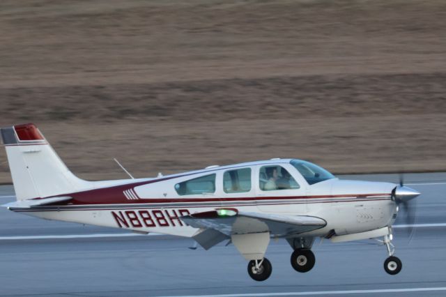 Beechcraft Bonanza (33) (N888HP) - Bonanza moments before touching down in Burlington. Not sure but it looked like a 3-point landing with a decent headwind. 