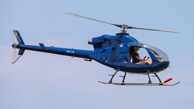 Cessna 421 (N911JE) - A Jet Exec helicopter does a low fly by as it approaches the T hangers where it will sit down.