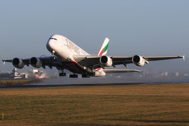 Airbus A380-800 (A6-EUY) - EK22 blasting some water off 23L on departure to DXB