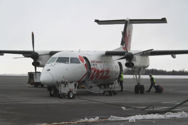 de Havilland Dash 8-300 (C-GKON) - This Dash-8 was making a quick turn-around at Kingston Airport (YGK) on a cold, grey day in late February.  The aircraft typically runs the service between Toronto Pearson and Kingston.