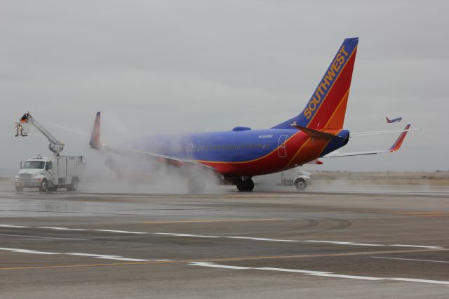 Boeing 737-700 (N496WN) - Deice operations at DIA on a cold and grey day.