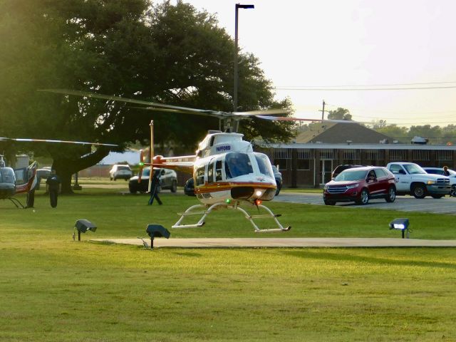 Bell 407 (N611PA) - Pafford Air One Echo taking off at Bolivar Medical Center with Air Evac 87 in the grass waiting for them to move