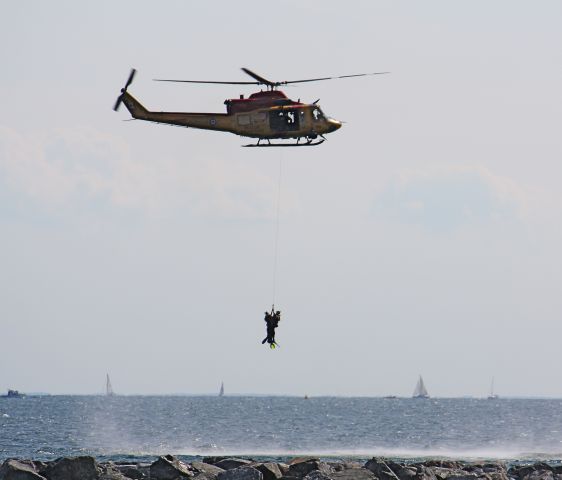 — — - Canadian Forces Helicopter demostrating rescue over Lake Ontario.
