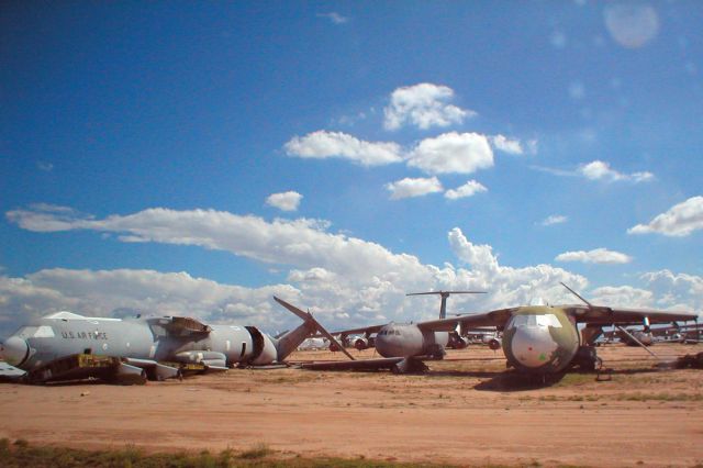 Lockheed C-141 Starlifter (C141) - Future beer cans: C141 Starlifters being destroyed for scrap at Davis-Monthan AFB, the Air Force Material Commands (AFMC) 309th Aerospace Maintenance and Regeneration Group (309 AMARG) - sometimes known as The Boneyard. Specifications (C-141B Starlifter)    General characteristics        * Crew: 56      * Length: 168 ft 4 in (51.3 m)      * Wingspan: 160 ft 0 in (48.8 m)      * Height: 39 ft 3 in (12 m)      * Wing area: 3,228 ft² (300 m²)      * Empty weight: 144,492 lb (65,542 kg)      * Max takeoff weight: 323,100 lb (147,000 kg)      * Powerplant: 4× Pratt & Whitney TF33-P-7 turbofans, 20,250 lbf (90.1 kN each) each    Performance        * Maximum speed: 567 mph (493 knots, 912 km/h)      * Range: 2,935 mi (2,550 nm, 4,723 km)      * Ferry range: 6,140 mi (5,330 nm, 9,880 km) unrefueled      * Service ceiling 41,000 ft (12,500 m)      * Rate of climb: 2,600 ft/min (13.2 m/s)      * Wing loading: 100.1 lb/ft² (490 kg/m²)      * Thrust/weight: 0.25