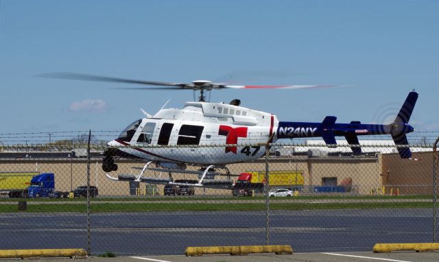 Bell 407 (N24NY) - LINDEN AIRPORT-LINDEN, NEW JERSEY, USA-APRIL 28, 2020: A helicopter from one of the local New York City T.V. stations is seen shortly after refueling after covering the joint flyover of the Blue Angels and Thunderbirds over New York and New Jersey during Operation America Strong, a salute to frontline COVID-19 responders.