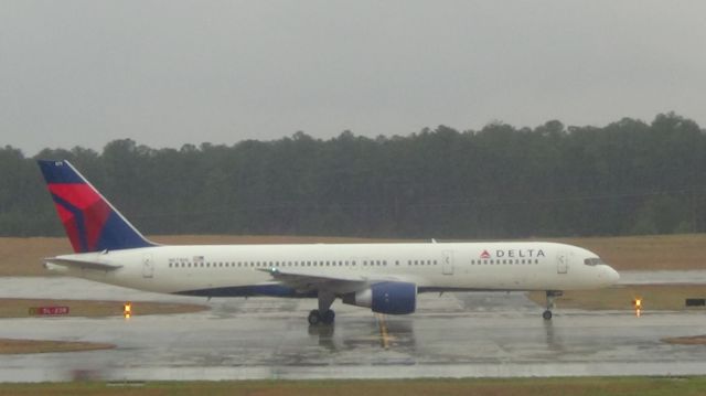 Boeing 757-200 (N671DN) - Delta 1666 going to depart to Atlanta at 5:27 P.M.  Taken March 19, 2015 during a steady rain.