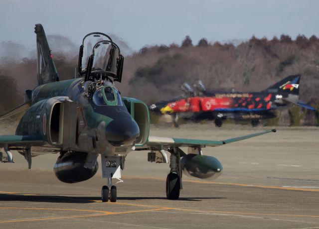 McDonnell Douglas F-4 Phantom 2 (57-6907) - RF-4EJ of the 501st squadron returning from a sortie while one of two specially painted F-4EJs of the 302nd squadron awaits in the back ground. (please view in "Full" for highest image quality)