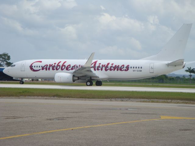 Boeing 737-800 (9Y-SXM) - Caribbean Airlines - Air Jamaicas latest addition to the B737 fleet is seen here operating BW600 POS-YYZ. Shes yet to receive her Humming Bird but still is a beauty.