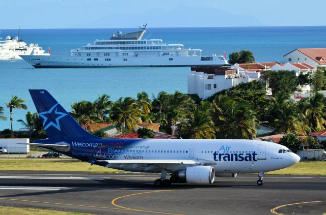 Airbus A310 (C-GTSF) - Air Transat taxing to line up for takeoff. (Look at the big boy toy in the background)