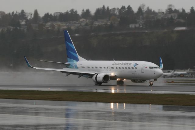 Boeing 737-700 (PK-GME) - From the roof of my Silverado during a slight rain squall.